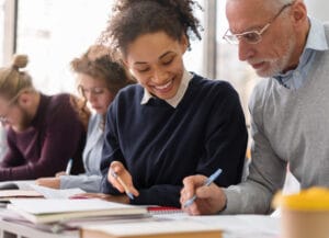 Learners taking notes in a classroom