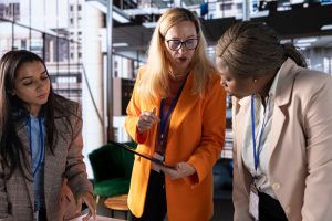 Three colleagues looking at a tablet together