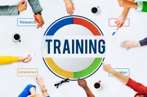 Hands around a table beside a graphic reading Training