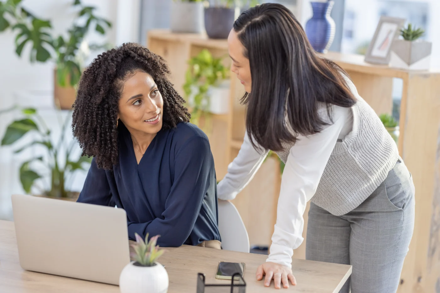 An employment specialist coaching a client one-to-one in a modern advice office