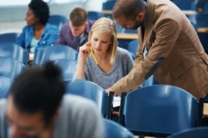 An FE lecturer leading a group of adult learners in a college classroom
