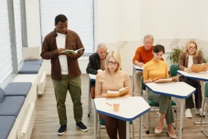 An adult education tutor leading a professional teacher-training session in a further education setting