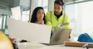 An assessor observing an adult apprentice being assessed at their workplace