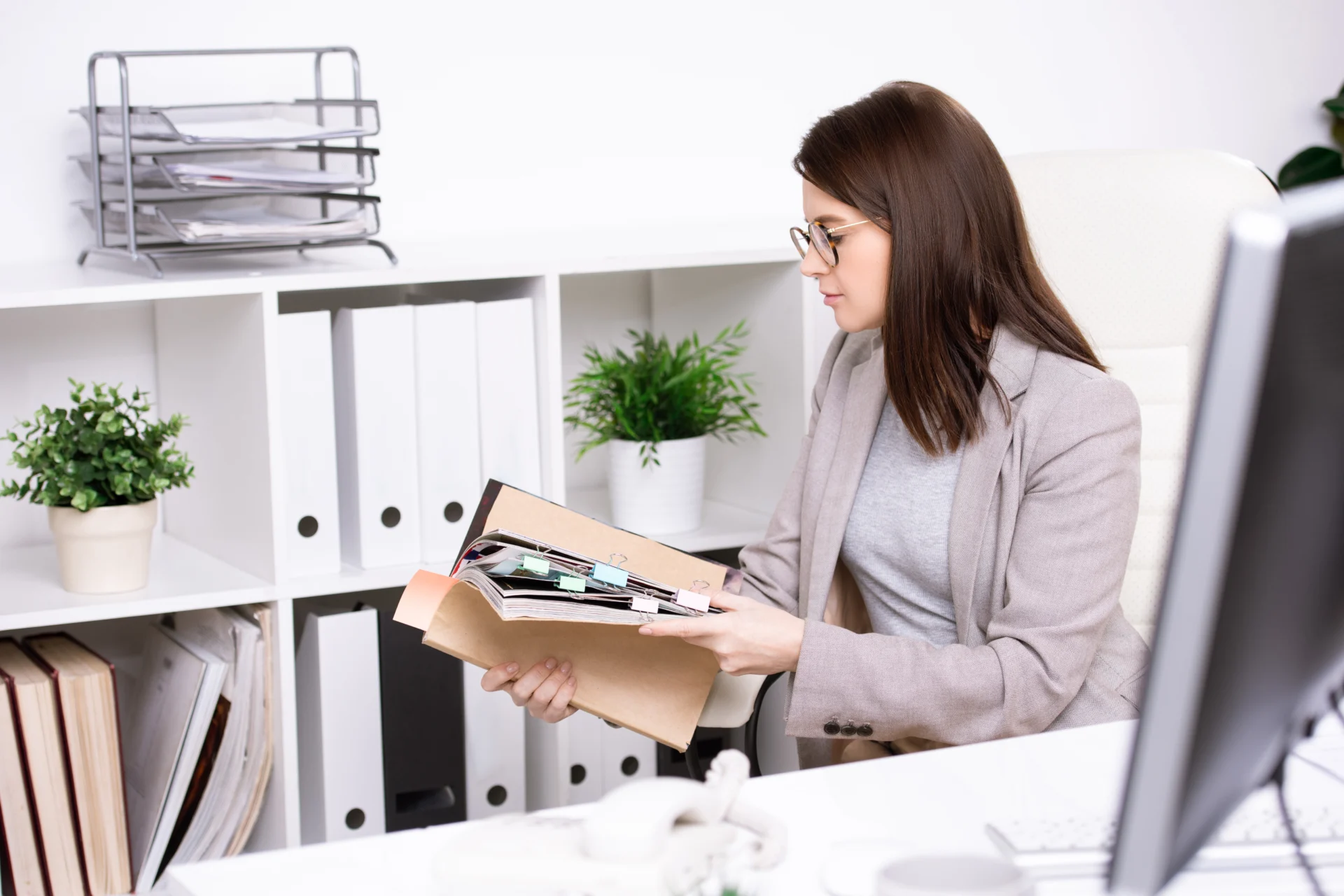 An internal quality assurer reviewing assessment records with an assessor in a training provider office