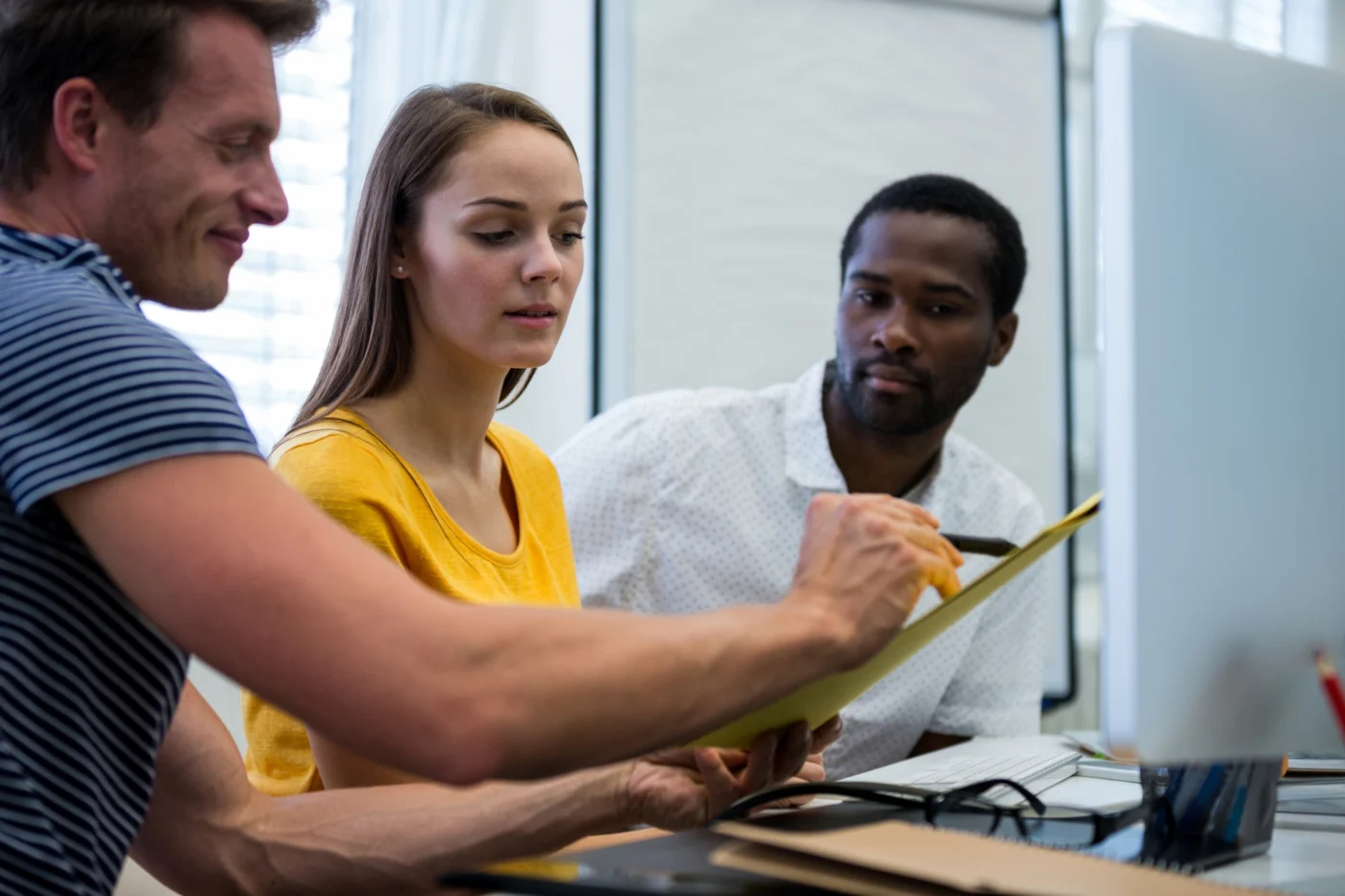 FE provider staff reviewing apprenticeship funding plans in an office meeting