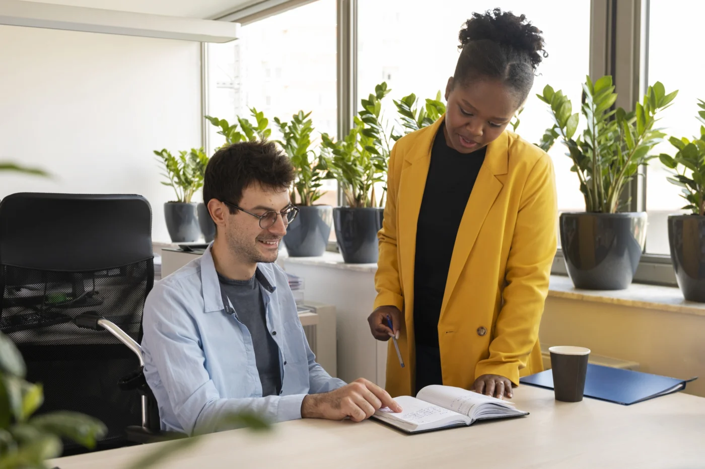 An employability advisor working one-to-one with a young adult in a community setting