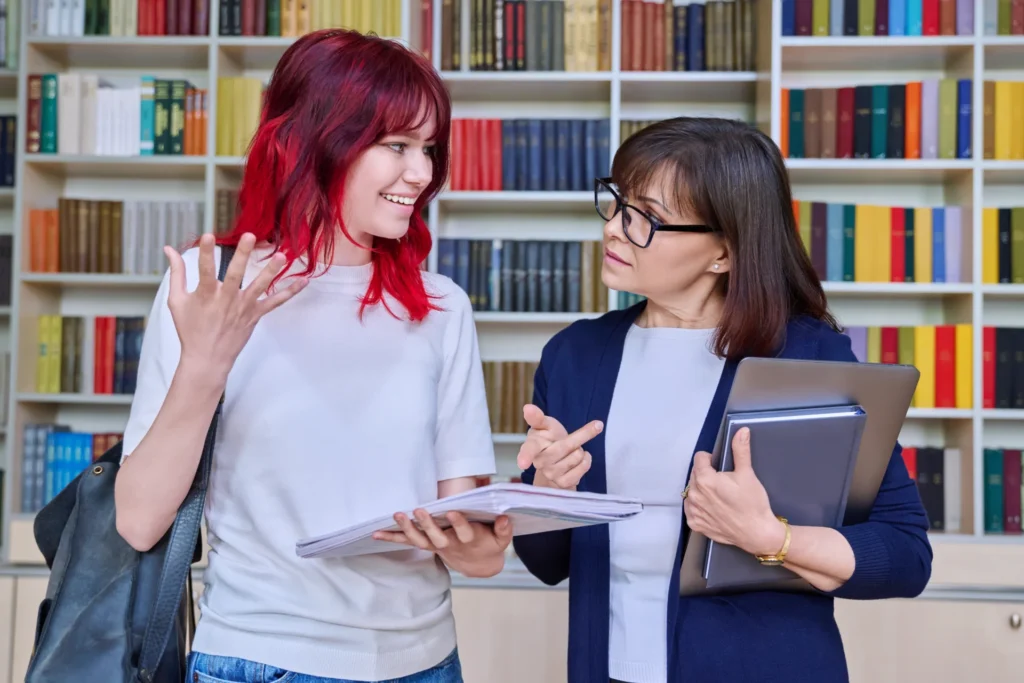 A learning mentor talking one to one with a college student