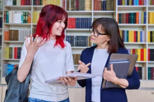 A learning mentor talking one to one with a college student