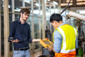 A young person in a first paid job being supported by a workplace mentor