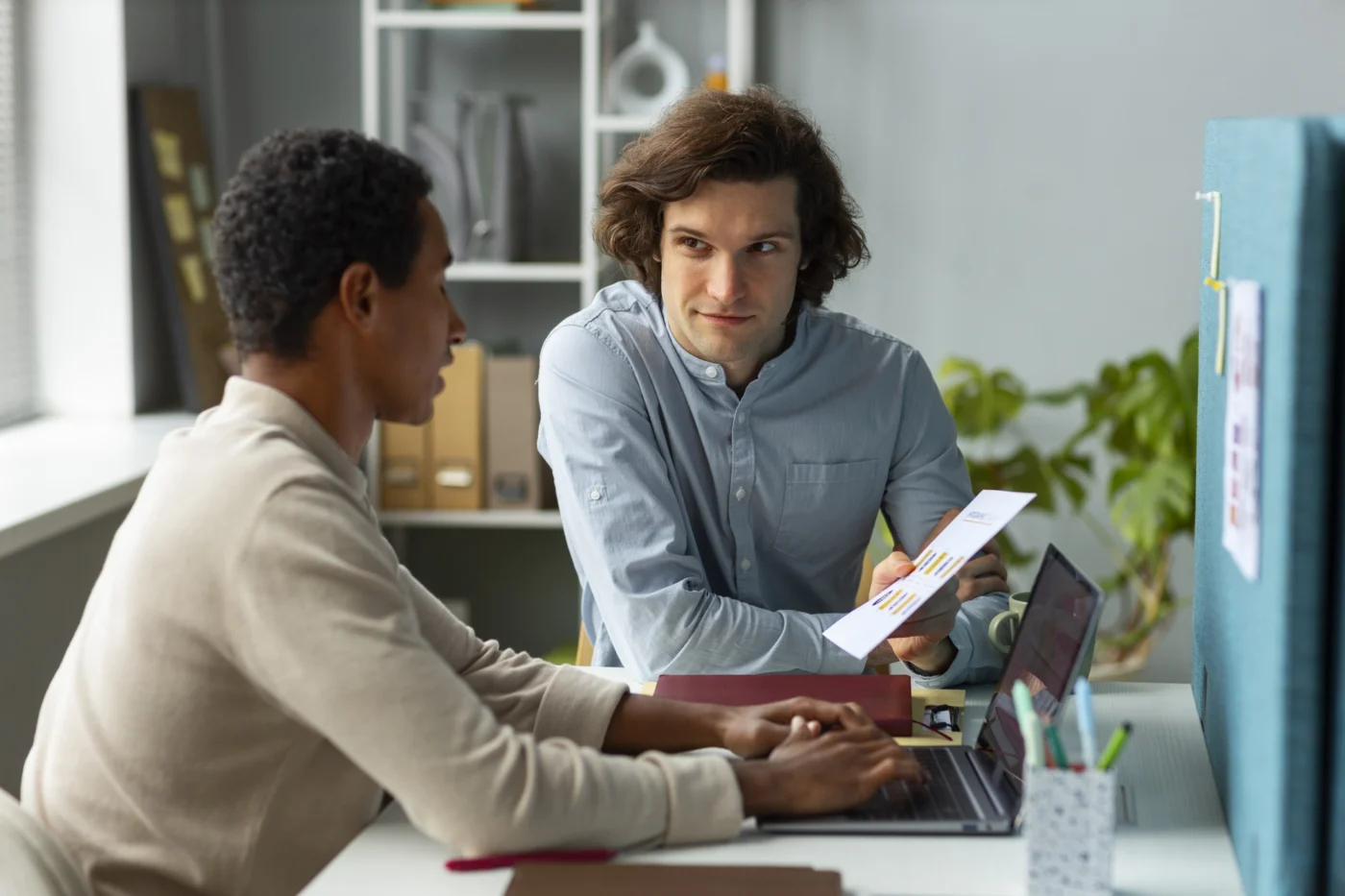 Two professionals discussing work matters in a casual meeting